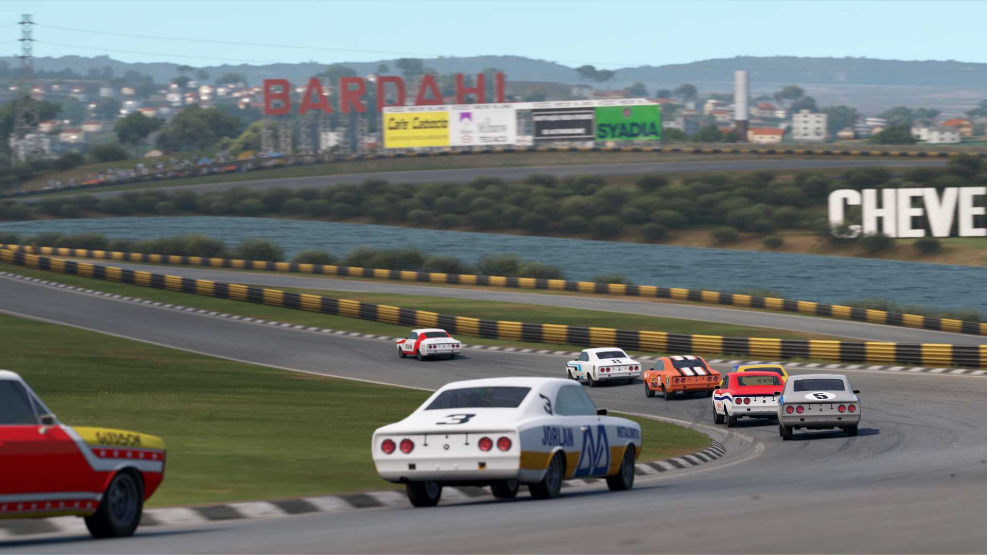 Opala 79s racing at Interlagos with a view of the surrounding city in the background